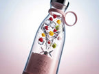 Close-up of a portable mini blender crushing ice and fresh fruit for smoothies